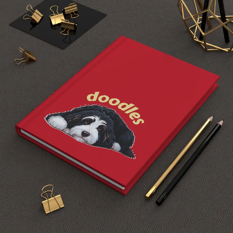 Red hardcover journal with a lying Bernedoodle under the word doodles